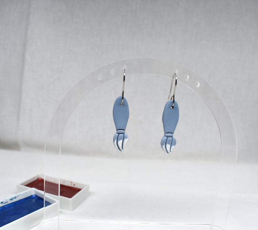 Handmade powder blue and silver polymer clay fishing bobber earrings on silver hooks
