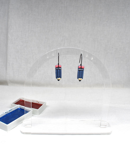 Handmade blue polymer clay pencil earrings with pink eraser top, gold ferrule band and yellow tip on matte black hooks
